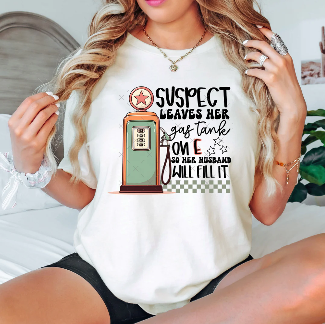 SUSPECT LEAVES HER GAS TANK ON E T-SHIRT